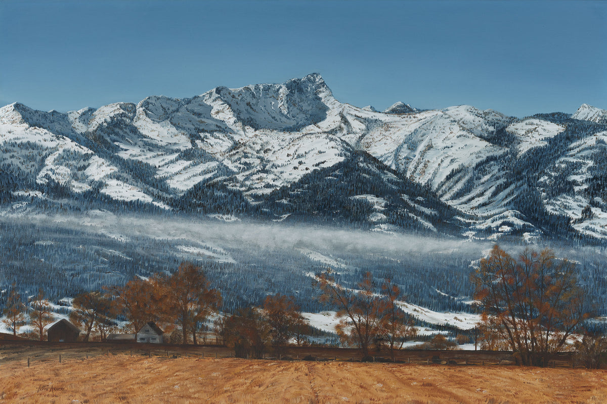 A scenic landscape artwork showing snow-covered mountains under a clear blue sky, with a valley of low clouds and trees in the foreground on dry brown ground.